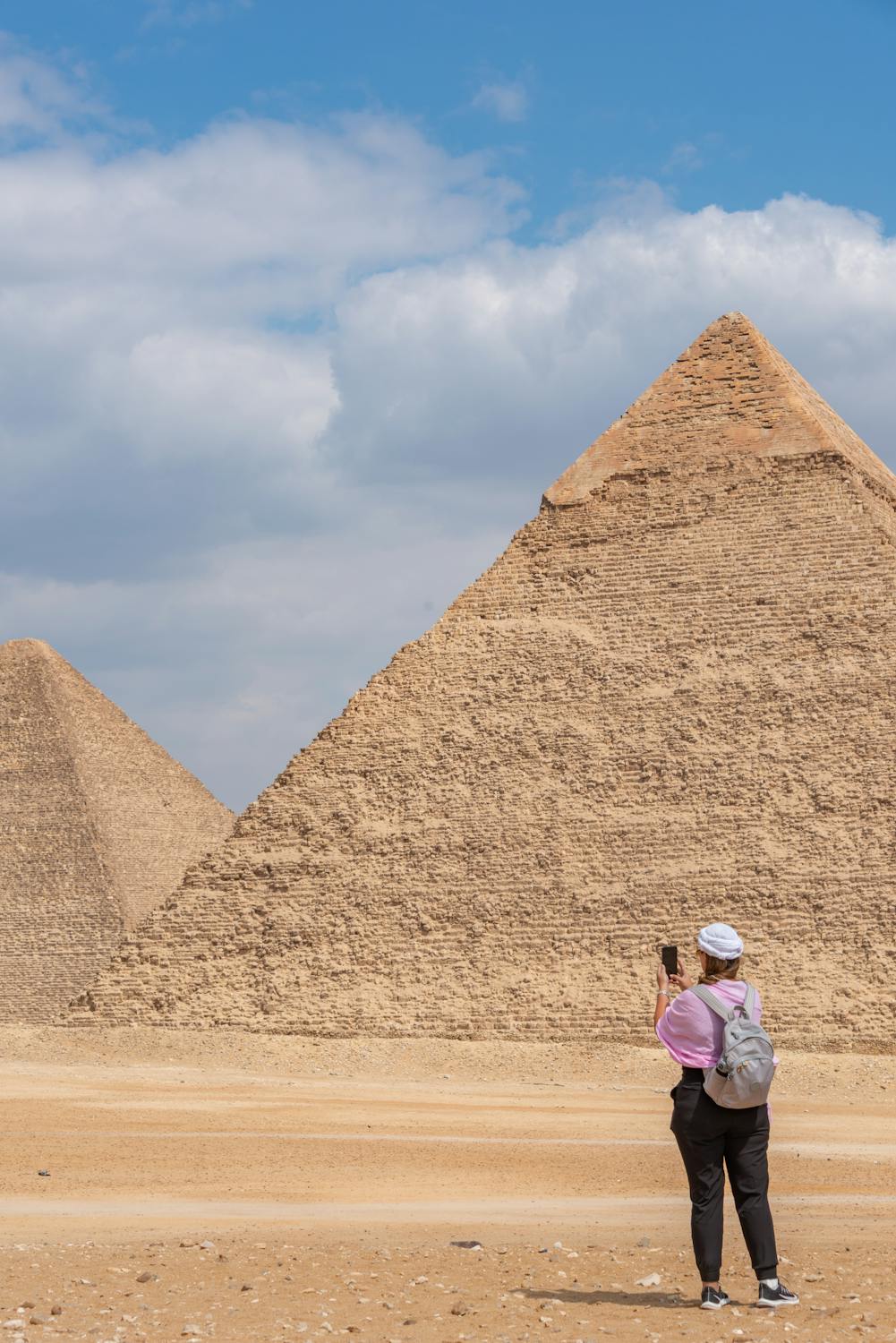free photo of woman taking pictures of pyramids